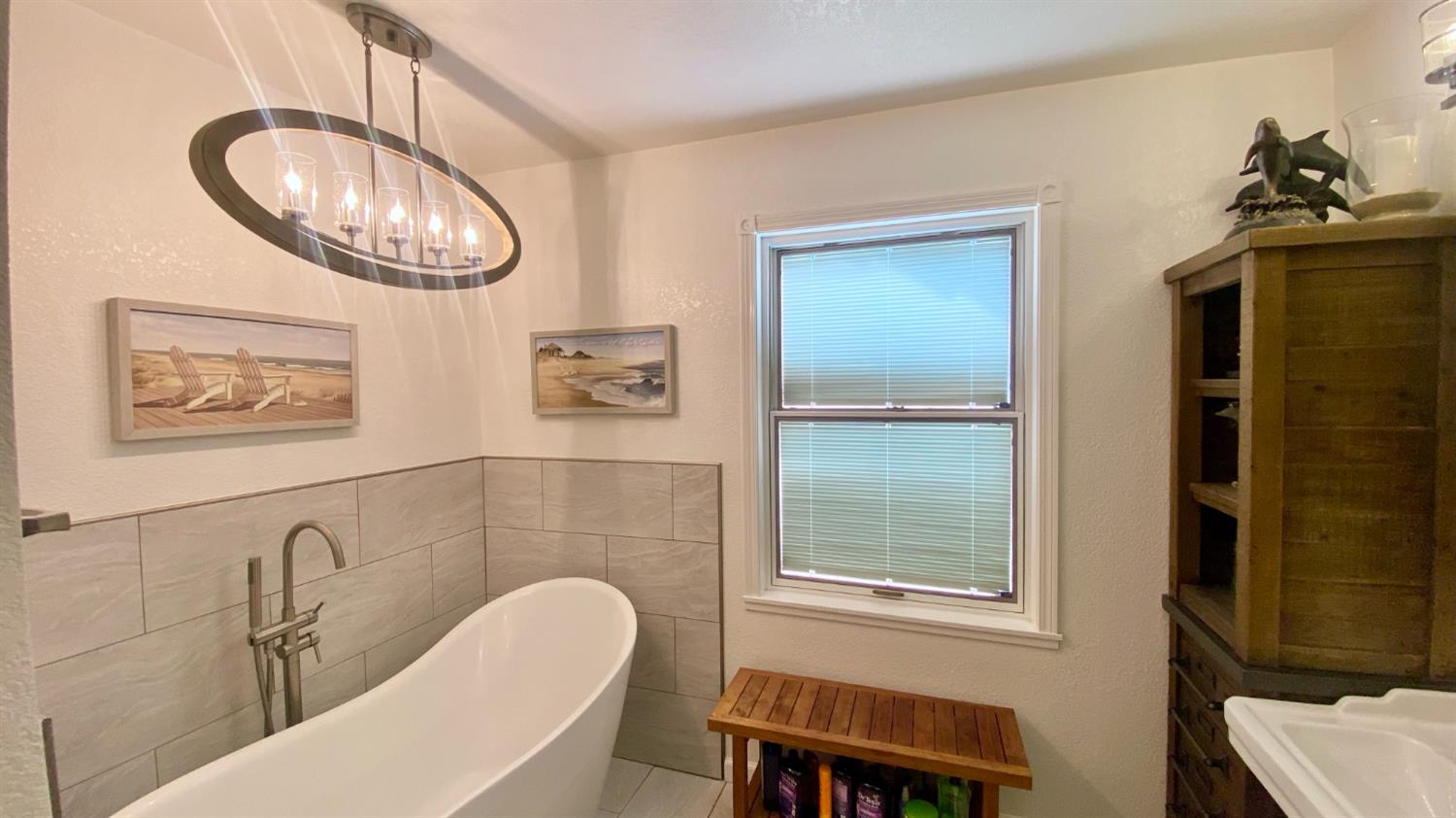 5012 Ustick Road Modesto, CA 95358 - Photo 25 of 26 a bathroom with a sink a mirror and a window