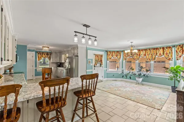 a dining room with furniture and window