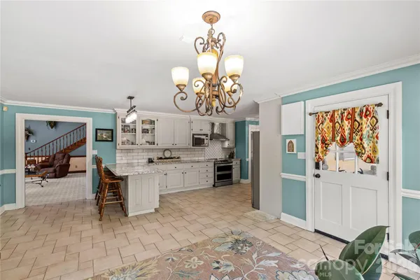 a kitchen with granite countertop a sink and cabinets