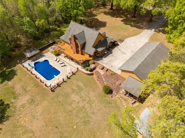 an aerial view of residential house with outdoor space and parking