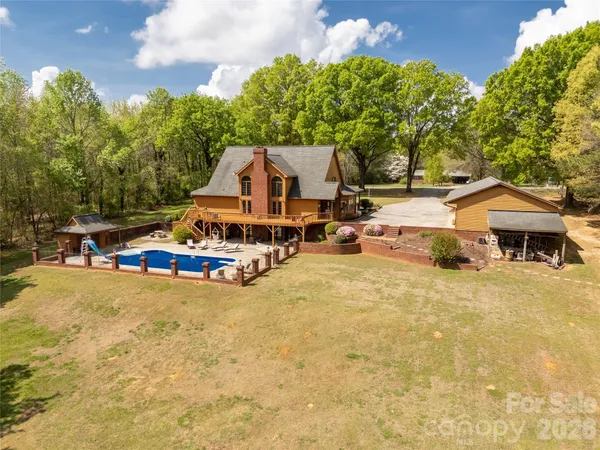 a view of a house with swimming pool and sitting area