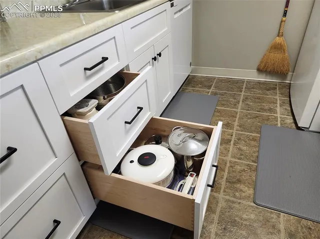 a kitchen with lots of bottles of alcohol