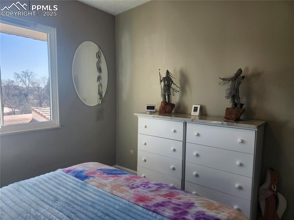 1038 Fontmore Road, Unit D Colorado Springs, CO 80904 - Photo 15 of 27 a bedroom with a bed and a closet