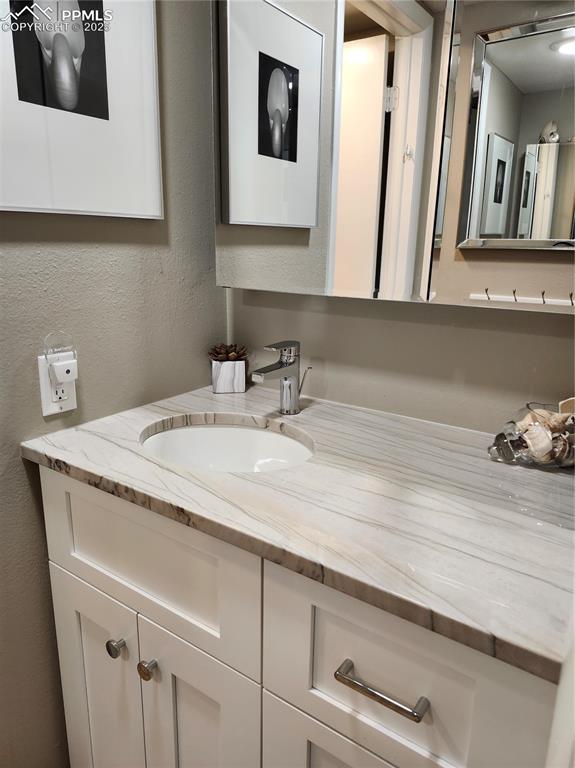 1038 Fontmore Road, Unit D Colorado Springs, CO 80904 - Photo 17 of 27 a bathroom with a sink and a mirror