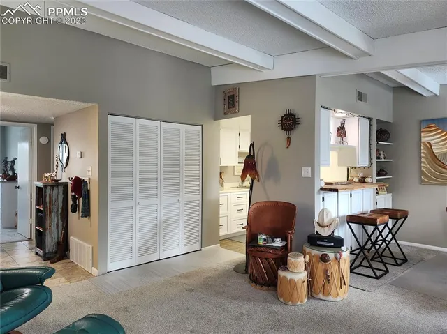 a living room with furniture and a mirror