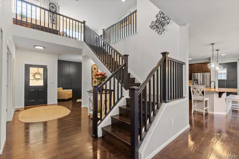a view of entryway and hall with wooden floor