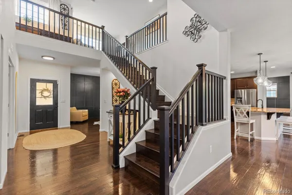 a view of entryway and hall with wooden floor