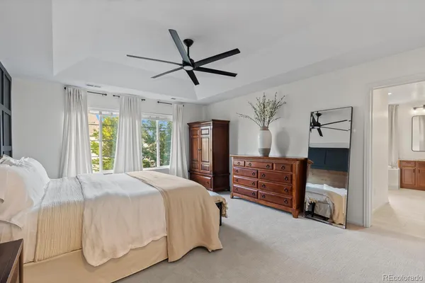a bedroom with a bed and a ceiling fan