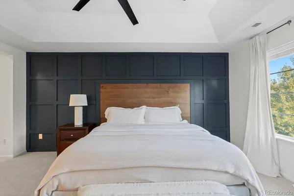 a bedroom with a bed and a night stand