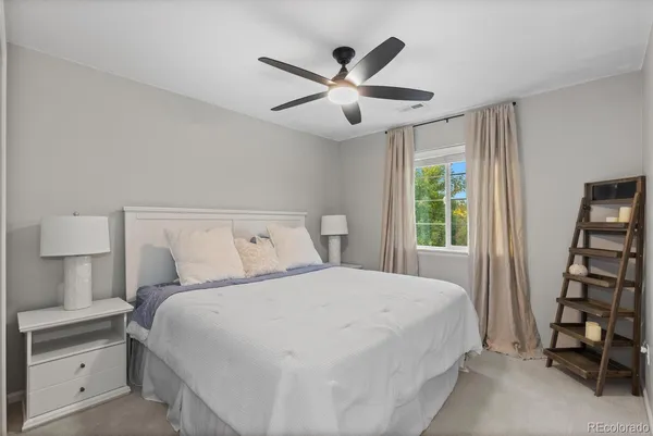a bedroom with a large bed and a chandelier
