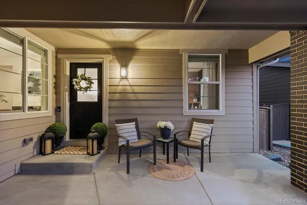 a view of patio with a table and chairs and potted plants