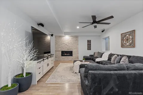 a living room with fireplace furniture and a flat screen tv