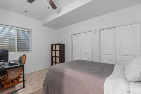 a bedroom with a bed and a book shelf