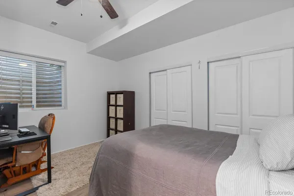 a bedroom with a bed and a book shelf