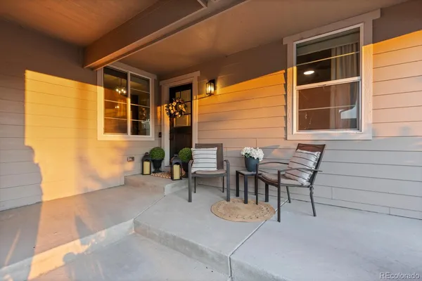 a view of a patio with table and chairs and potted plants