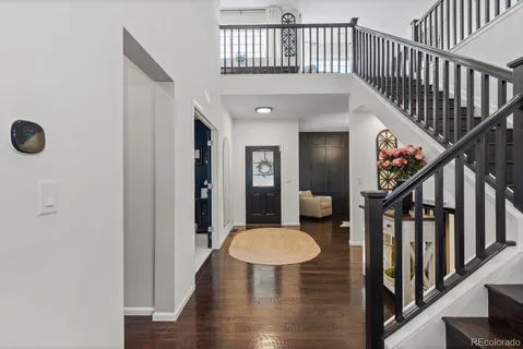 a view of entryway and hall with wooden floor