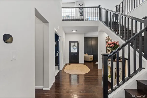 a view of entryway and hall with wooden floor