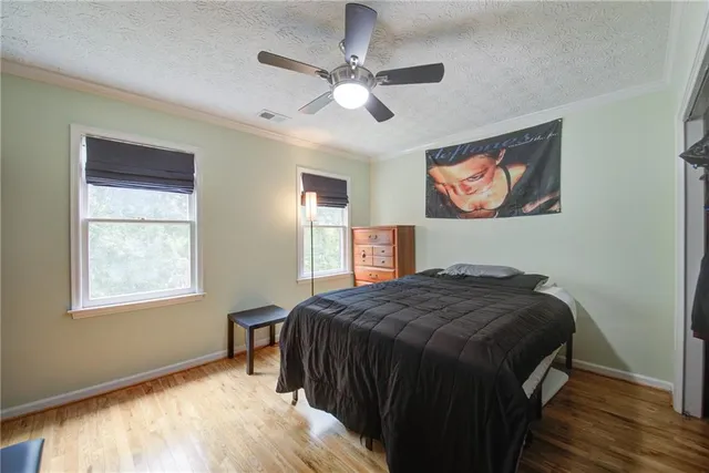 a view of hallway with stairs and wooden floor