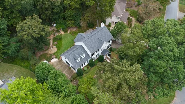 an aerial view of a house with a yard