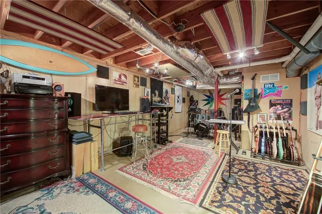 a living room with furniture and a floor to ceiling window