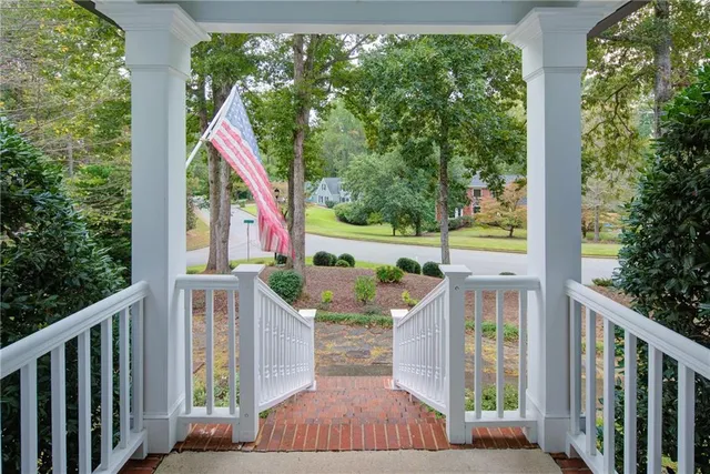 a view of a hallway with a livingroom and furniture