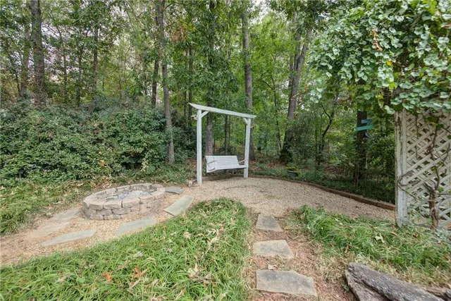 an aerial view of residential house with outdoor space and trees all around
