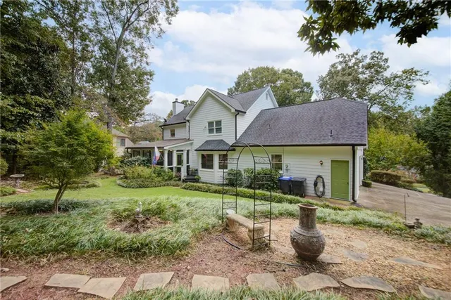 a view of a tennis ground with large trees