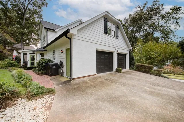 an aerial view of a house with garden space and street view
