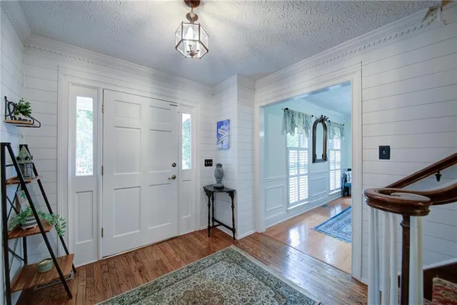 a view of a dining room with furniture wooden floor and windows