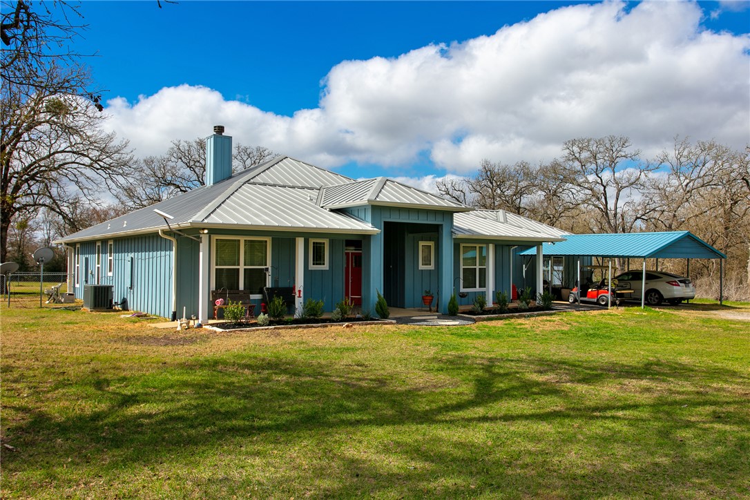 4168 Owensville Cemetery Road Franklin, TX 77856 - Photo 2 of 35 a front view of a building with a garden