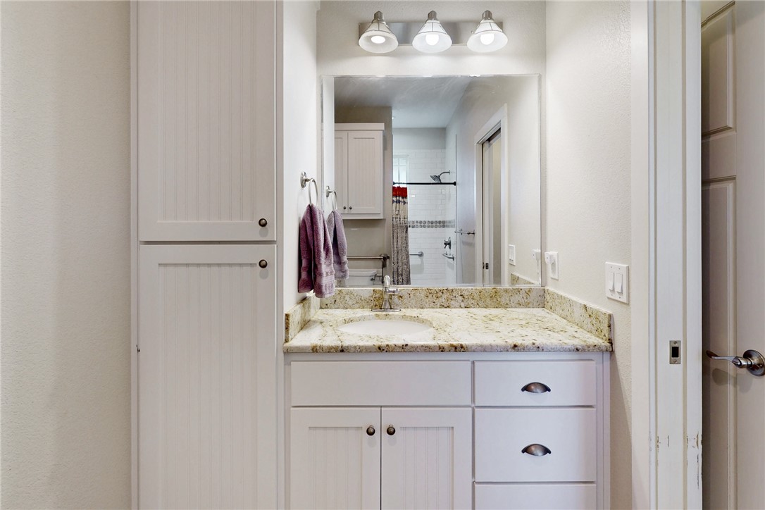 4168 Owensville Cemetery Road Franklin, TX 77856 - Photo 21 of 35 a bathroom with a granite countertop sink and a mirror