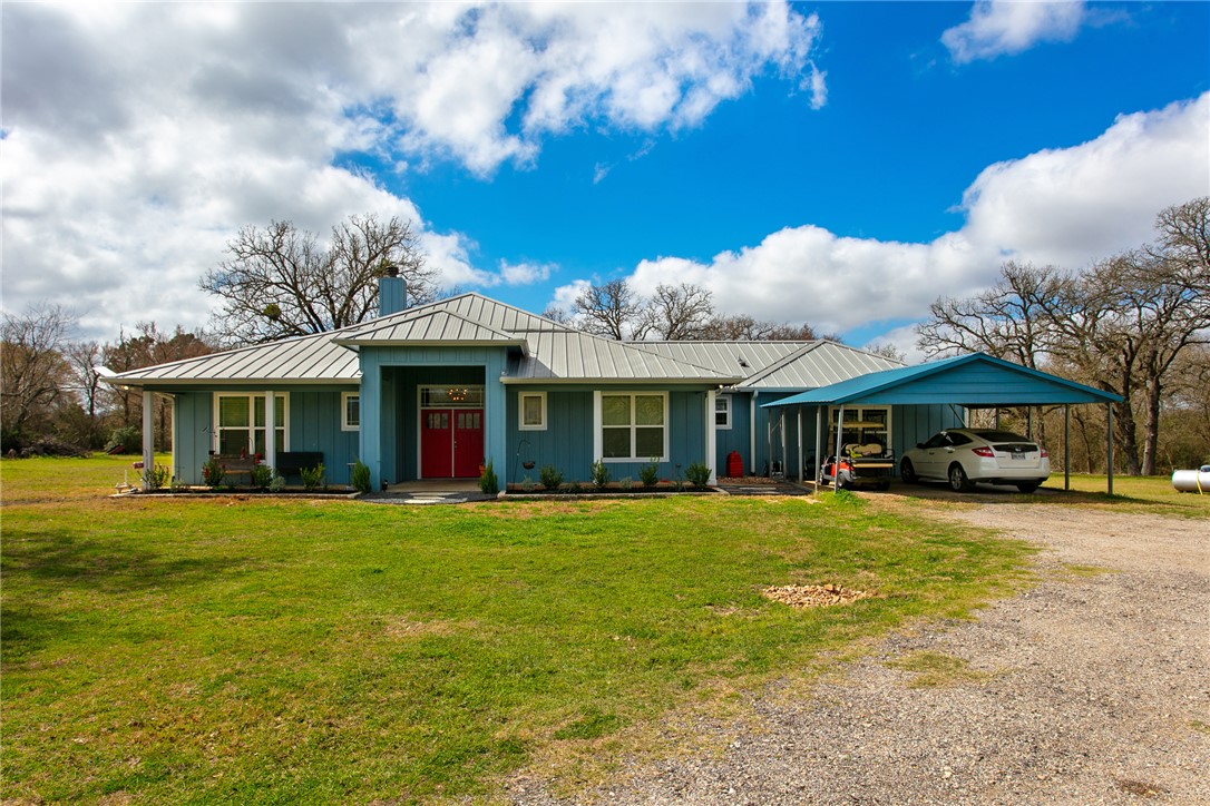 4168 Owensville Cemetery Road Franklin, TX 77856 - Photo 5 of 35 a front view of a house with a garden