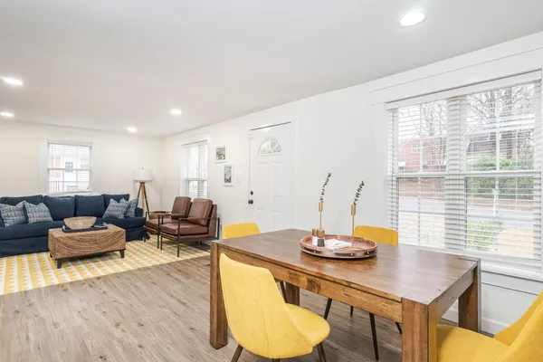 a kitchen with white cabinets and sink