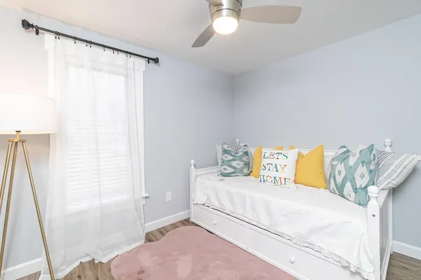 a bedroom with a bed and a chandelier