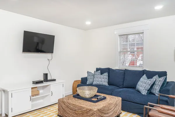 a living room with furniture and a rug