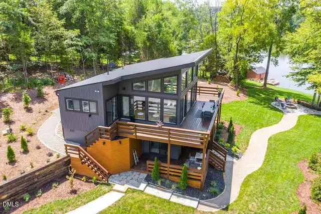 an aerial view of a house with backyard porch and sitting area