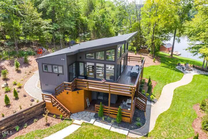 an aerial view of a house with backyard porch and sitting area