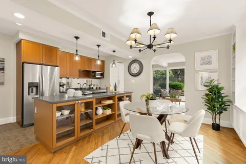 a kitchen with stainless steel appliances granite countertop a sink a stove and a refrigerator