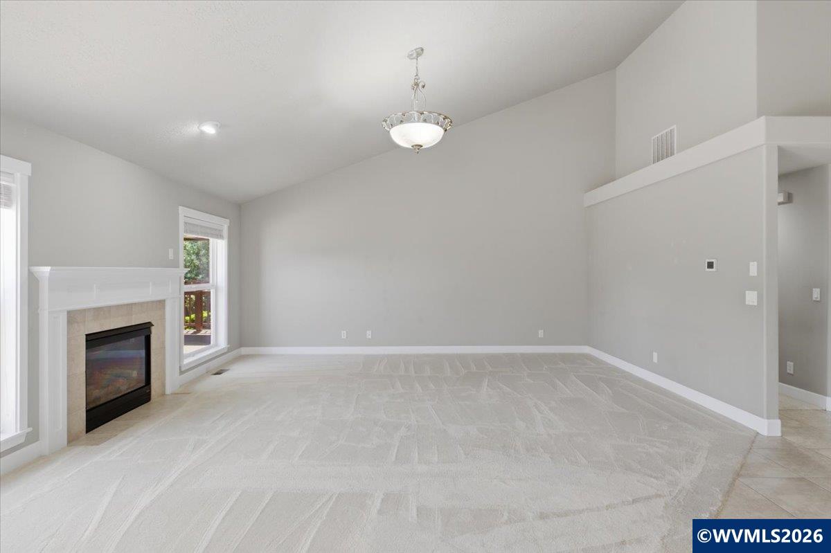 2359 Northwest Gale Street Albany, OR 97321 - Photo 17 of 47 an empty room with fireplace and wooden floor