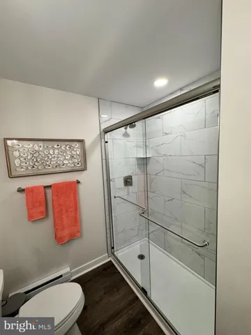 a bathroom with a shower a toilet and sink
