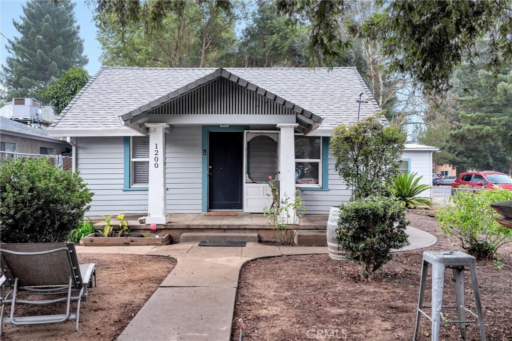 a front view of house with yard outdoor seating and green space
