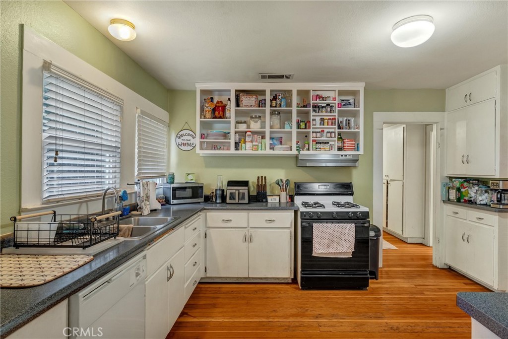 1200 Ivy Street Chico, CA 95928 - Photo 11 of 31 a kitchen with stainless steel appliances granite countertop a stove and a sink