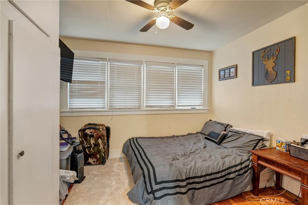 1200 Ivy Street Chico, CA 95928 - Photo 15 of 31 a bedroom with a bed and a chandelier