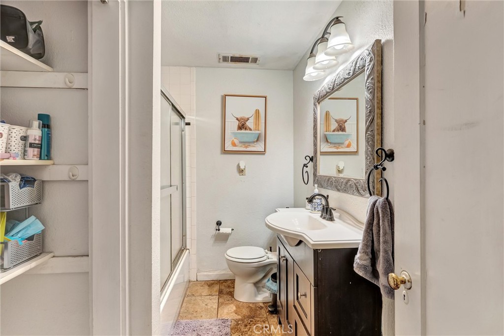 1200 Ivy Street Chico, CA 95928 - Photo 17 of 31 a bathroom with a sink a toilet and shower curtain