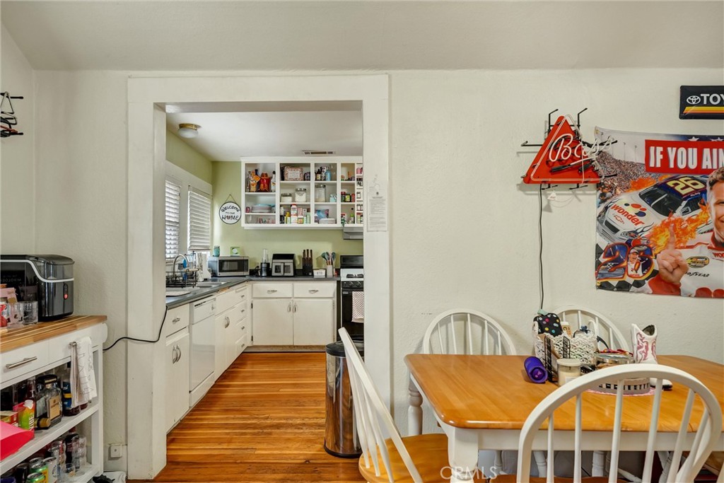 1200 Ivy Street Chico, CA 95928 - Photo 9 of 31 a kitchen with stainless steel appliances granite countertop a dining table chairs stove and white cabinets