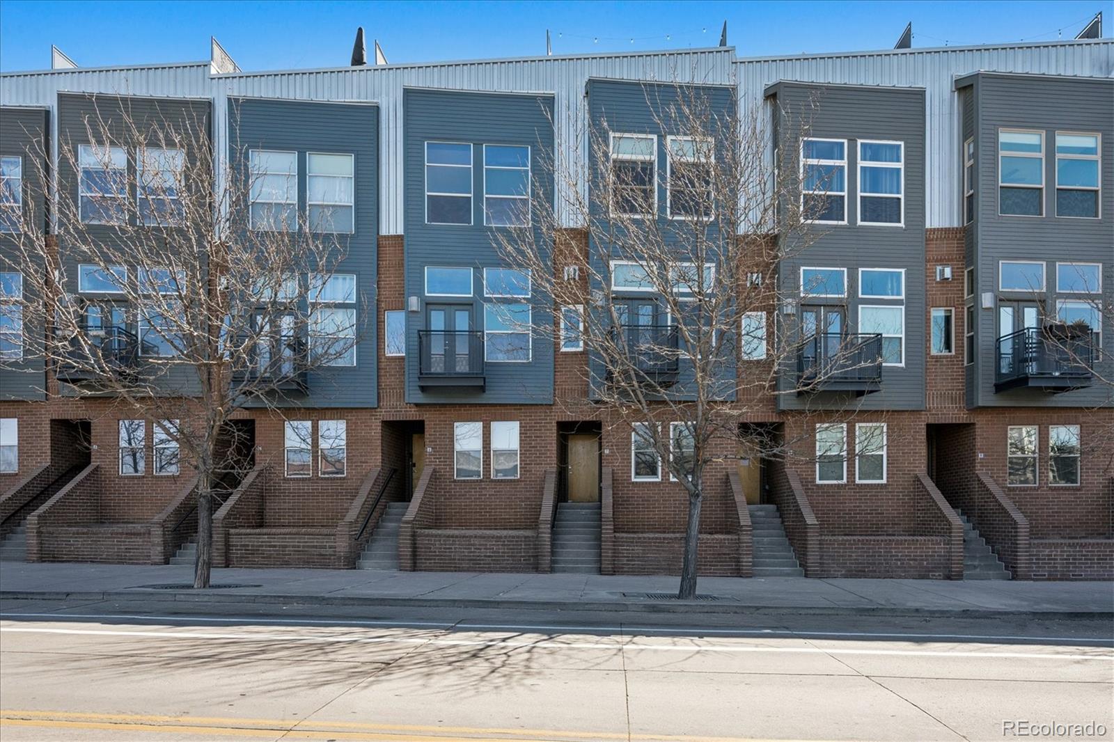 2680 Blake Street, Unit 7 Denver, CO 80205 - Photo 1 of 36 a front view of a residential apartment building with a yard