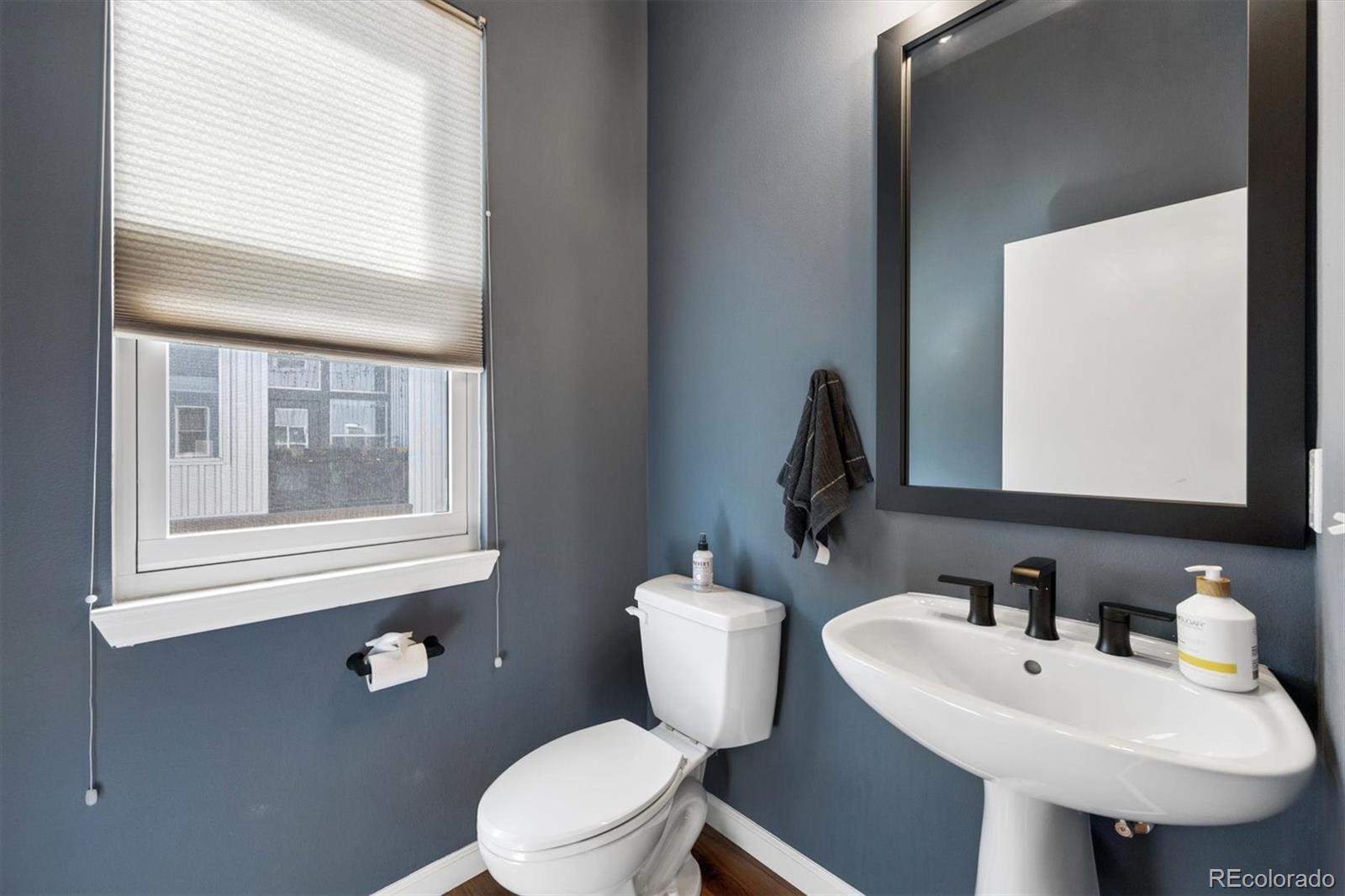 2680 Blake Street, Unit 7 Denver, CO 80205 - Photo 13 of 36 a bathroom with a toilet sink and mirror