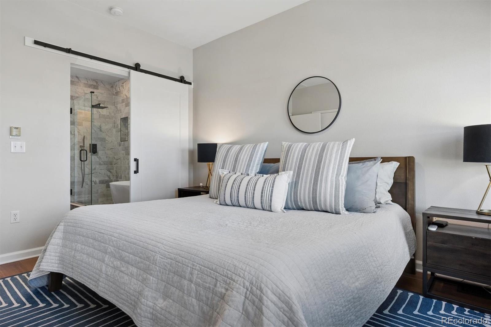 2680 Blake Street, Unit 7 Denver, CO 80205 - Photo 15 of 36 a bedroom with a bed and a mirror