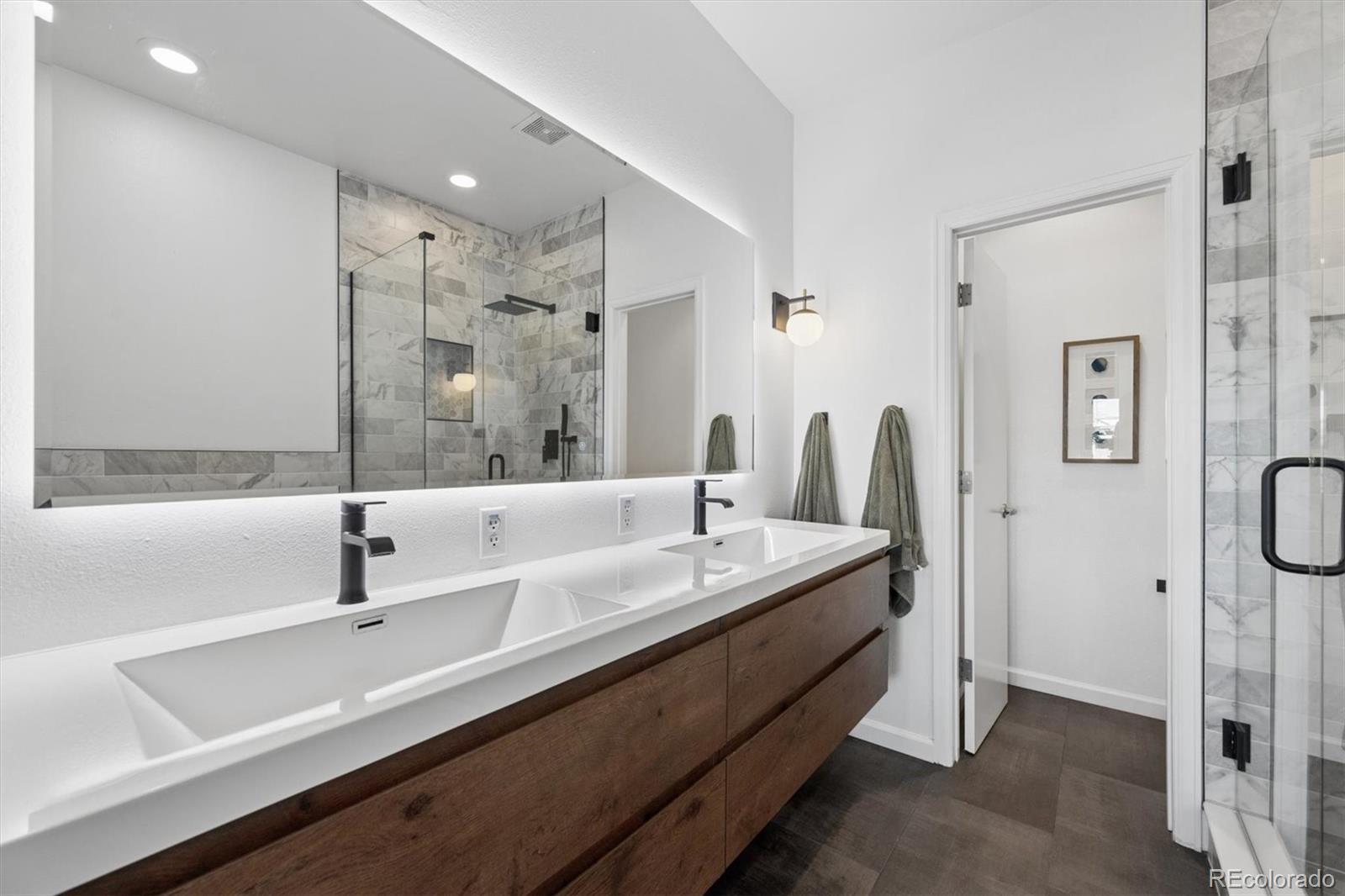 2680 Blake Street, Unit 7 Denver, CO 80205 - Photo 17 of 36 a bathroom with a double vanity sink a mirror and shower