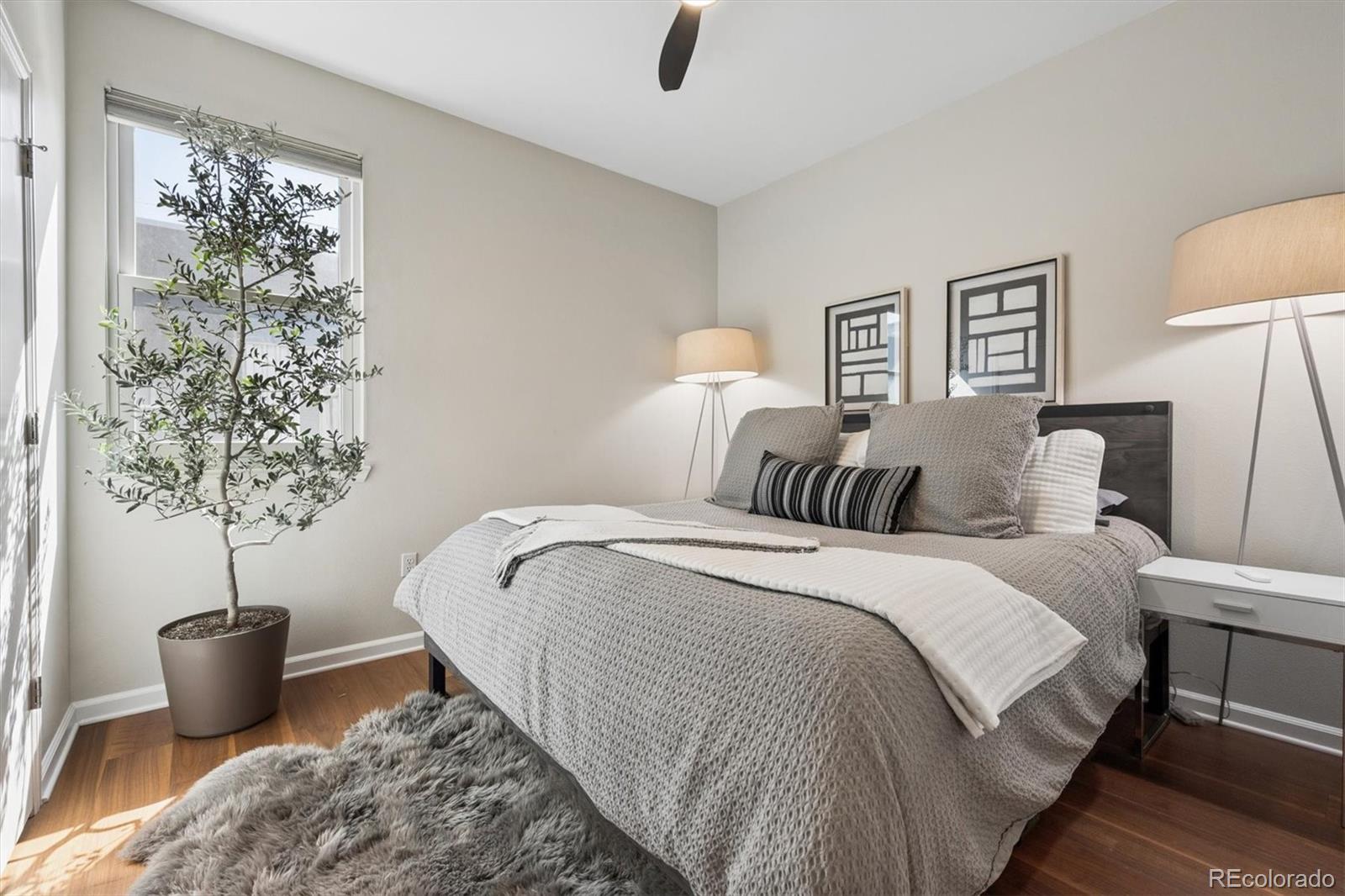 2680 Blake Street, Unit 7 Denver, CO 80205 - Photo 19 of 36 a bedroom with bed and a potted plant